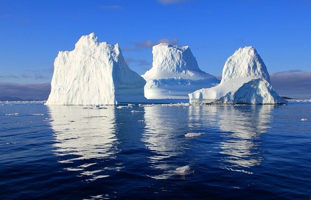 Greenland - icebergs - sea - blue sky