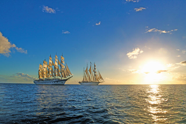 Star Clipper ships on the ocean at sunset